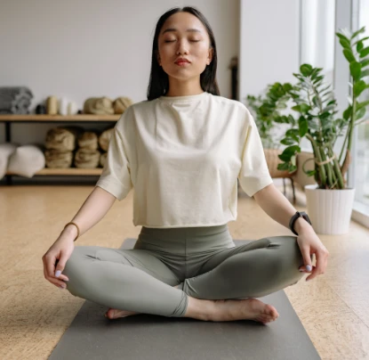 woman meditating inside