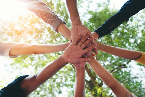 diverse partners hands held together in circle