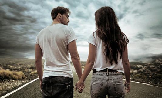 happy couple walking on a road