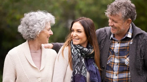 woman embracing older  woman and man