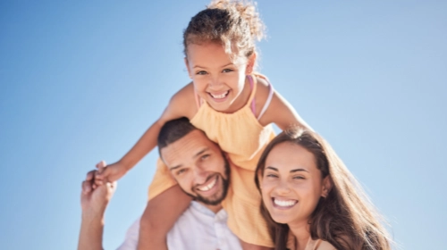 happy family outside with blue sky