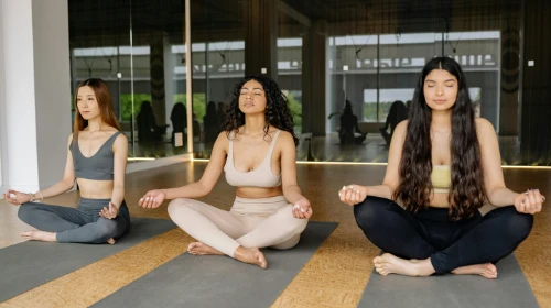 women meditating in yoga class