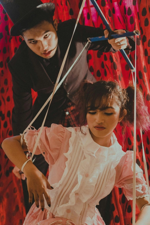 female puppet controlled by male puppet master