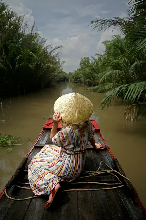 woman in hat sitting in boat