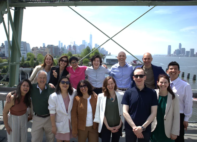 laughing OME Team in front of New York skyline