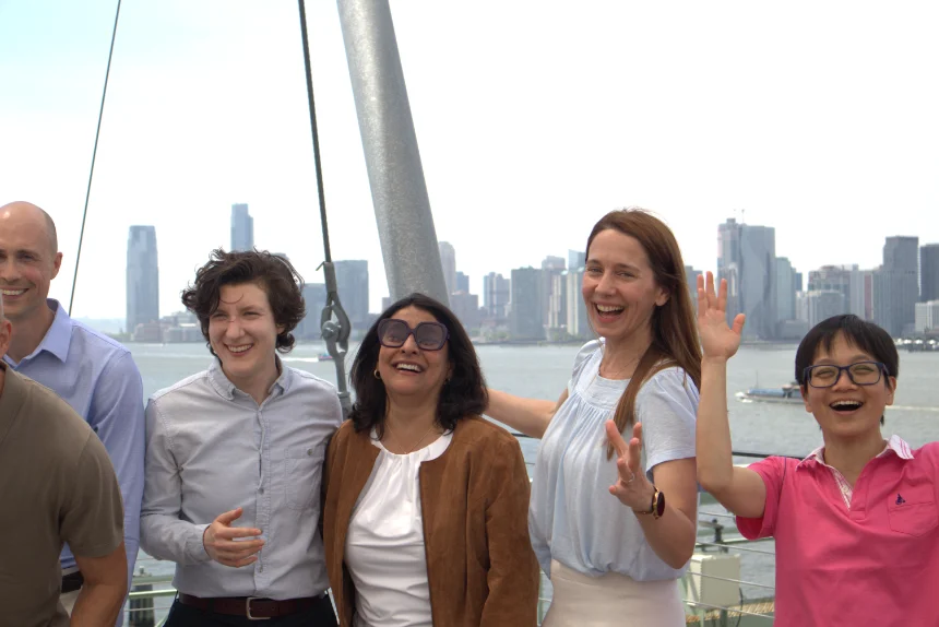 laughing people in front of New York skyline